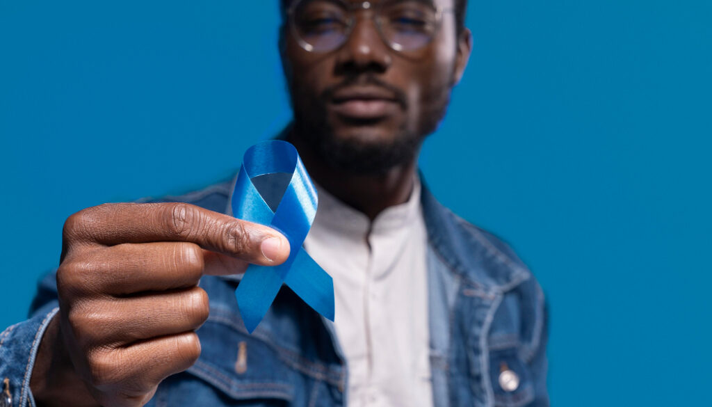 african-american-man-holding-a-blue-ribbon