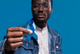african-american-man-holding-a-blue-ribbon